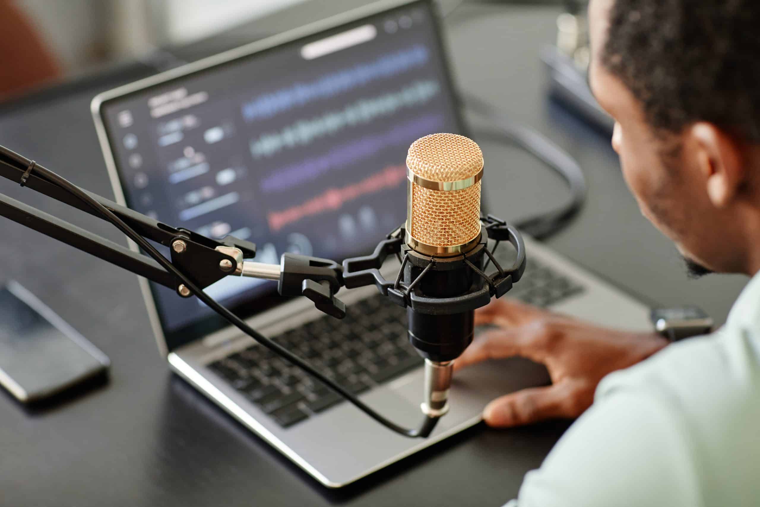 High angle close up of a man recording podcast at home
