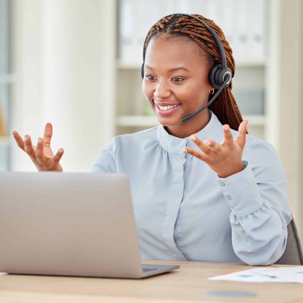 A woman hosting a laptop webinar or workshop training on online zoom meeting in company or startup office.